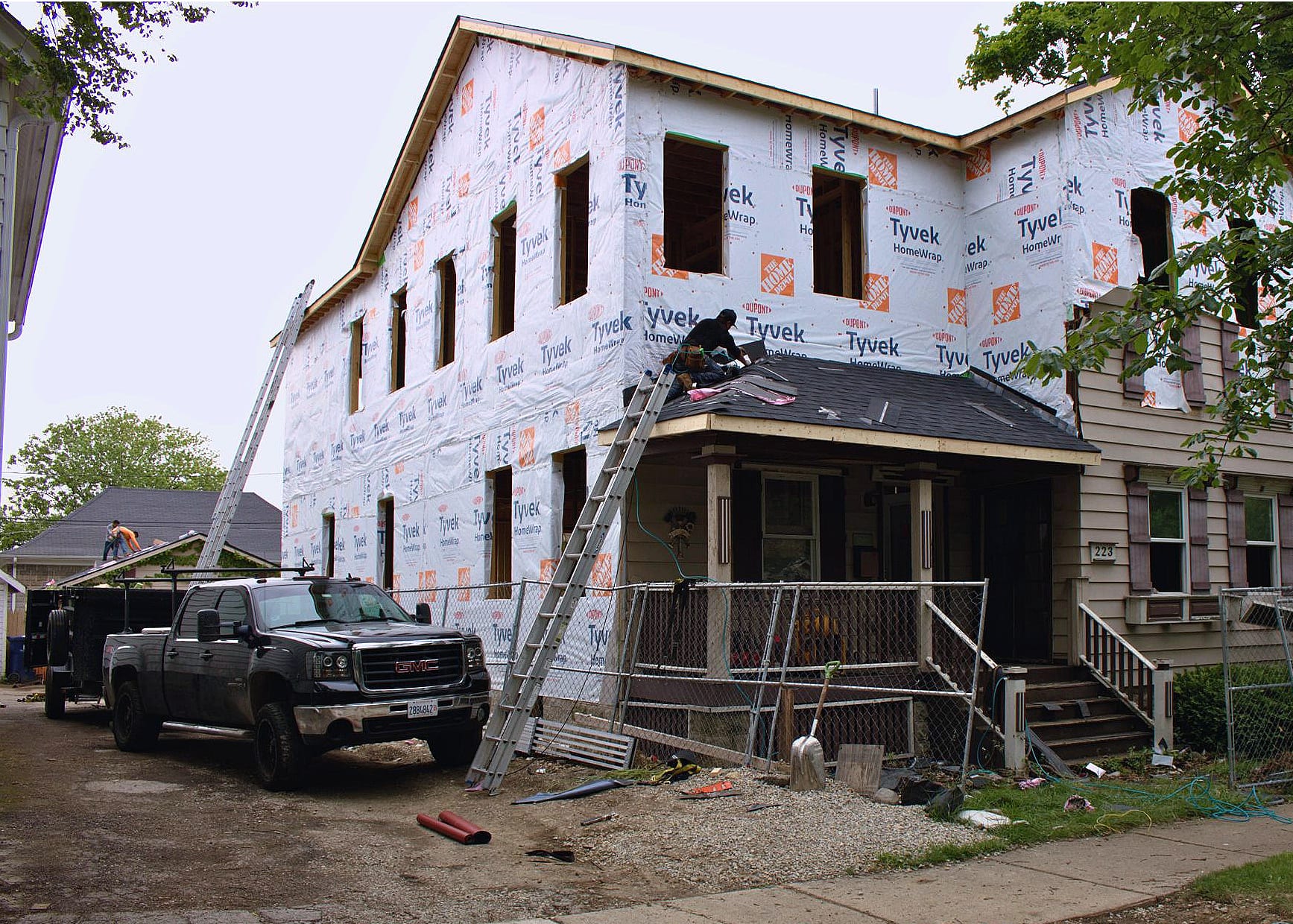 Revere One Construction crew re-roofing a Chicagoland home wrapped in housewrap